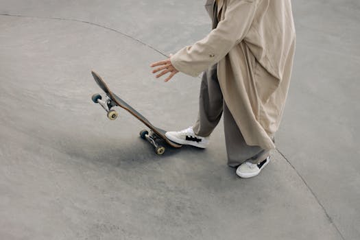 A modern skateboarding scene featuring a stylish individual in a long trench coat at the skate park.