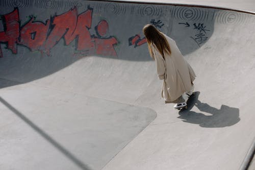 Free A Woman Riding a Skateboard in the Skatepark Stock Photo