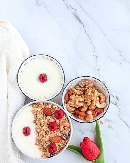 Bowls with Musli, Nuts and Yogurt on a Countertop