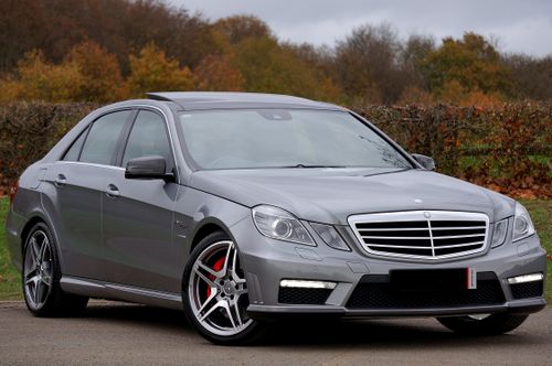 Free A sleek luxury silver Mercedes Benz parked on a road outdoors in autumn. Stock Photo