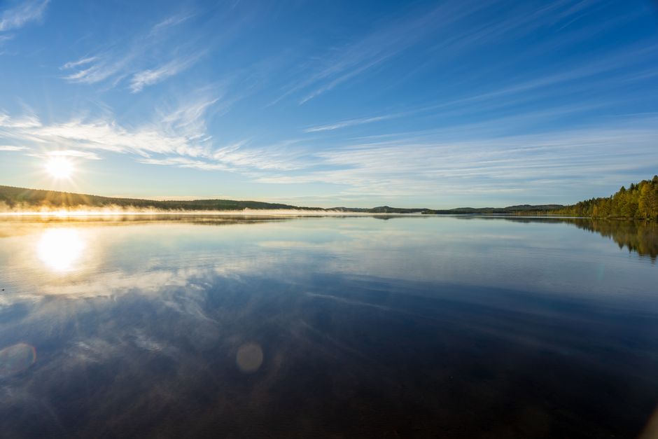 Bright sky at midnight over a lake in Kiruna, northern Sweden during the Midnight Sun