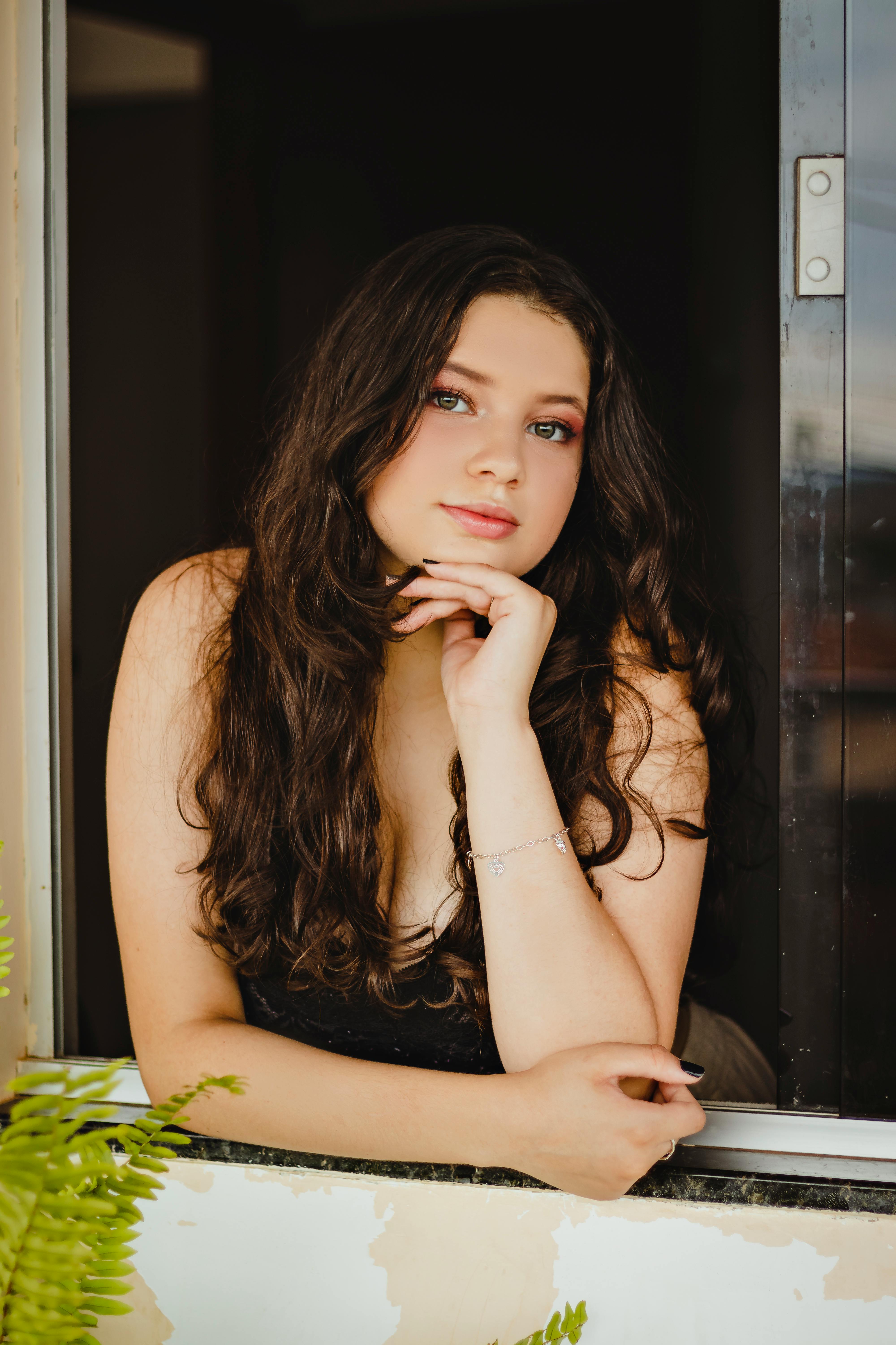 girl leaning on windowsill