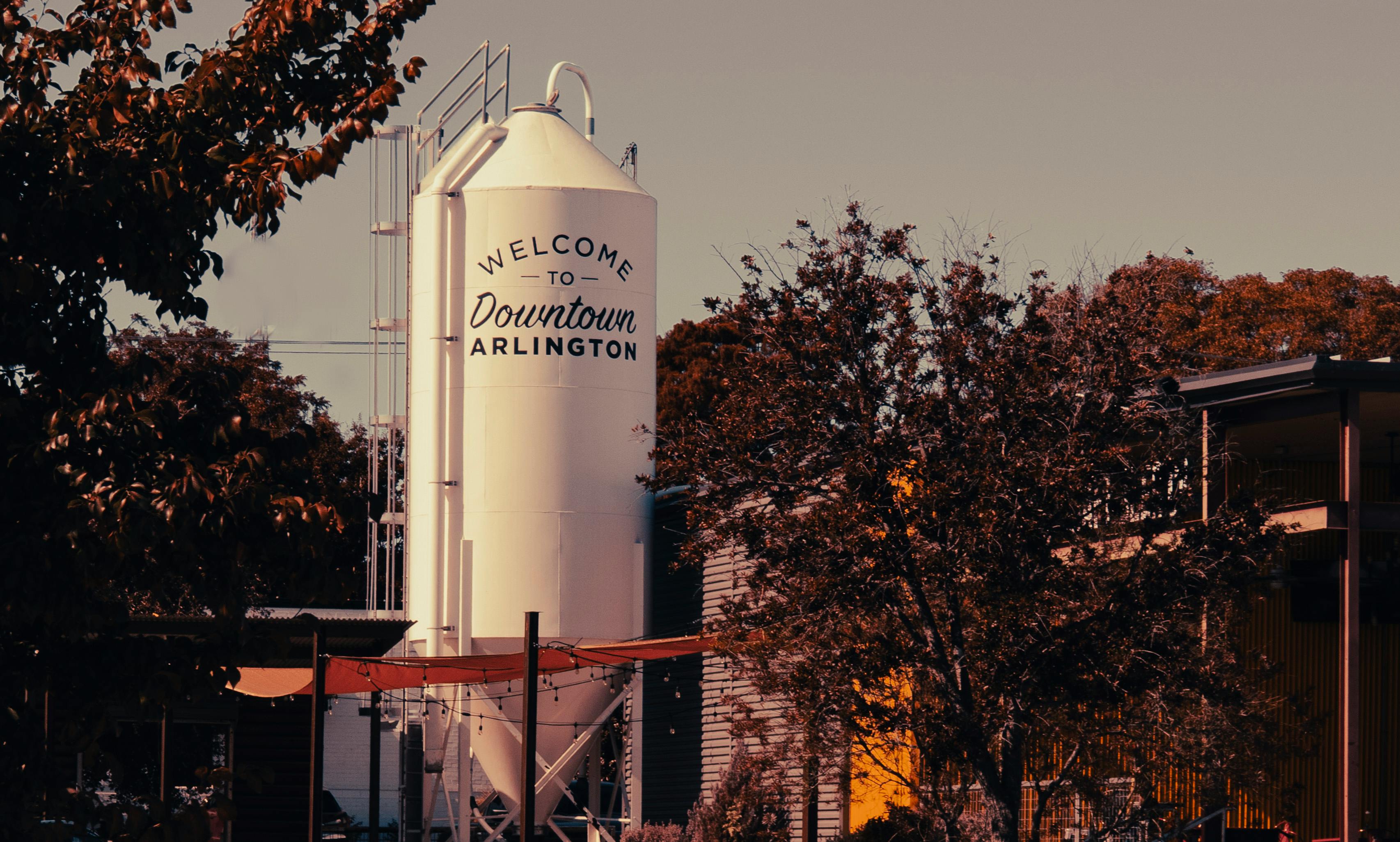 Industrial scene in Arlington, Texas featuring a prominent silo and surrounding autumn foliage.