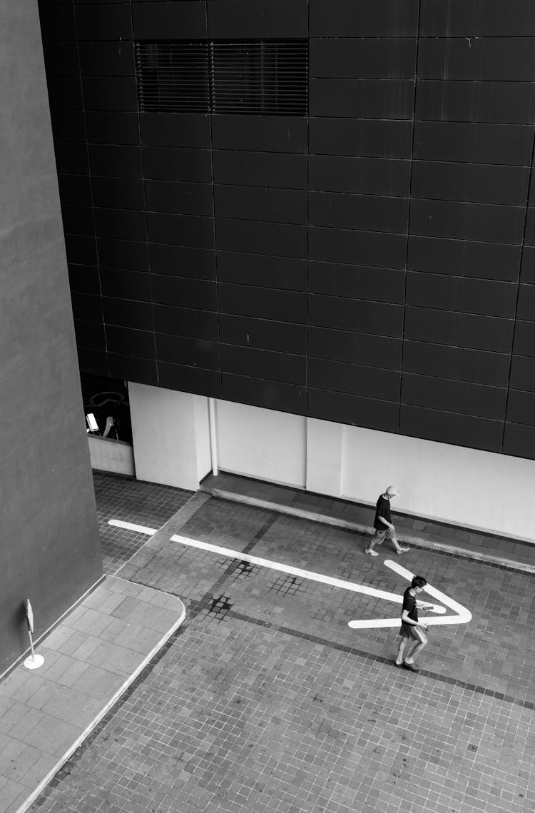 High Angle Shot Of Men Walking On The Sidewalk