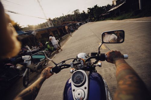 Free Experience the thrill of a motorcycle ride on a vibrant street, capturing everyday life in motion. Stock Photo