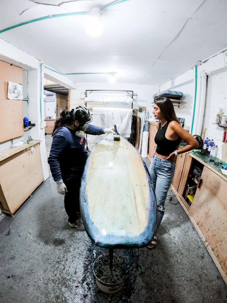 Women Painting Surfboard