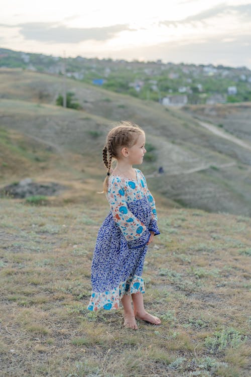 A Girl Standing Barefooted On the Grass