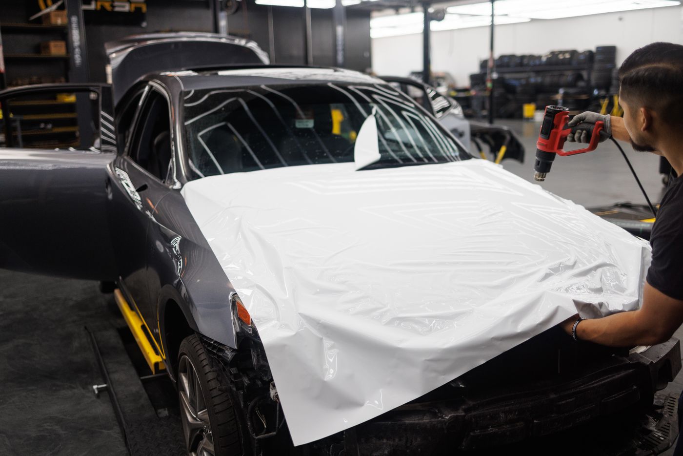 Car being wrapped in a workshop