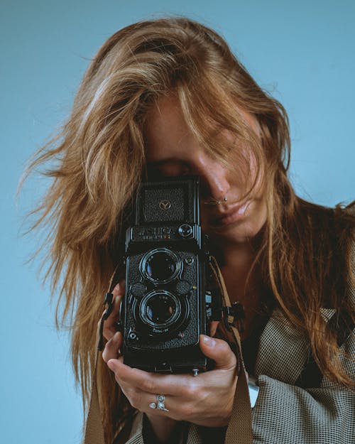 A Woman Using a Vintage Camcorder