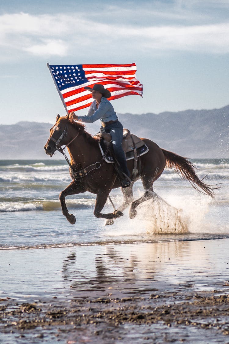 Woman On Galloping Horse Holding American Flag 