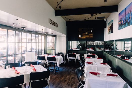 Inviting retro-style restaurant interior with neatly arranged tables and a warm ambiance.