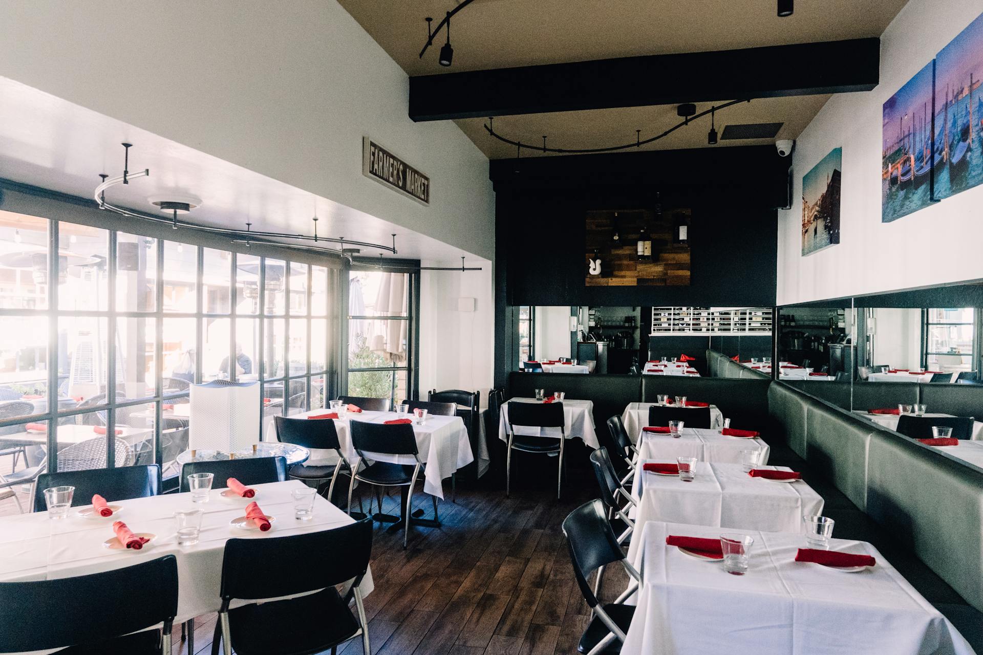 Retro Style Bar Interior with White Tablecloths and Red Napkins