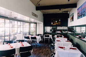Retro Style Bar Interior with White Tablecloths and Red Napkins