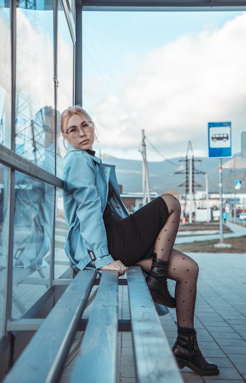 Free Blonde Woman Sitting on Wooden Bench  Stock Photo