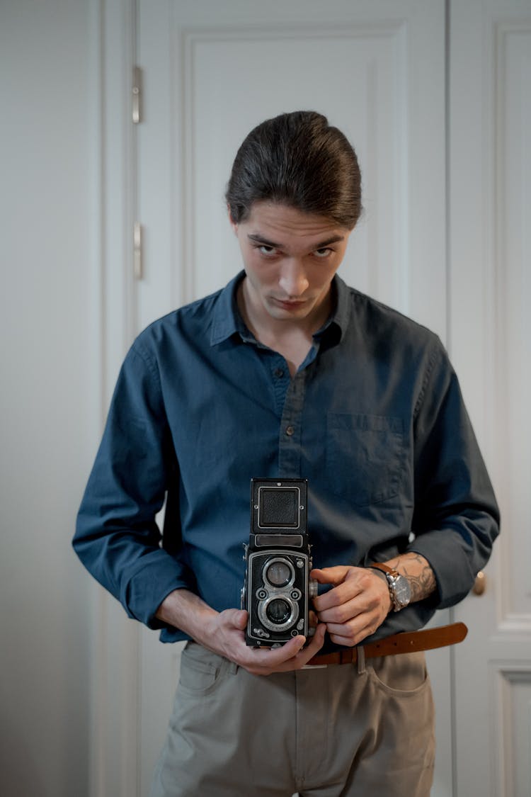 Man In Blue Button Down Shirt Holding Analog Camera