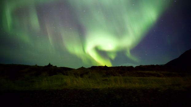 Stunning aurora borealis illuminates the Icelandic night sky with vibrant colors.