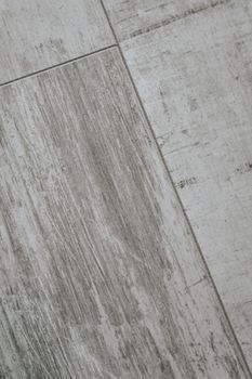 Detailed close-up of grey wooden tile texture, showcasing the natural wood grain pattern and monochrome feel.