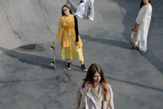 Stylish women with skateboards in an urban skatepark. A modern take on skate culture and fashion.