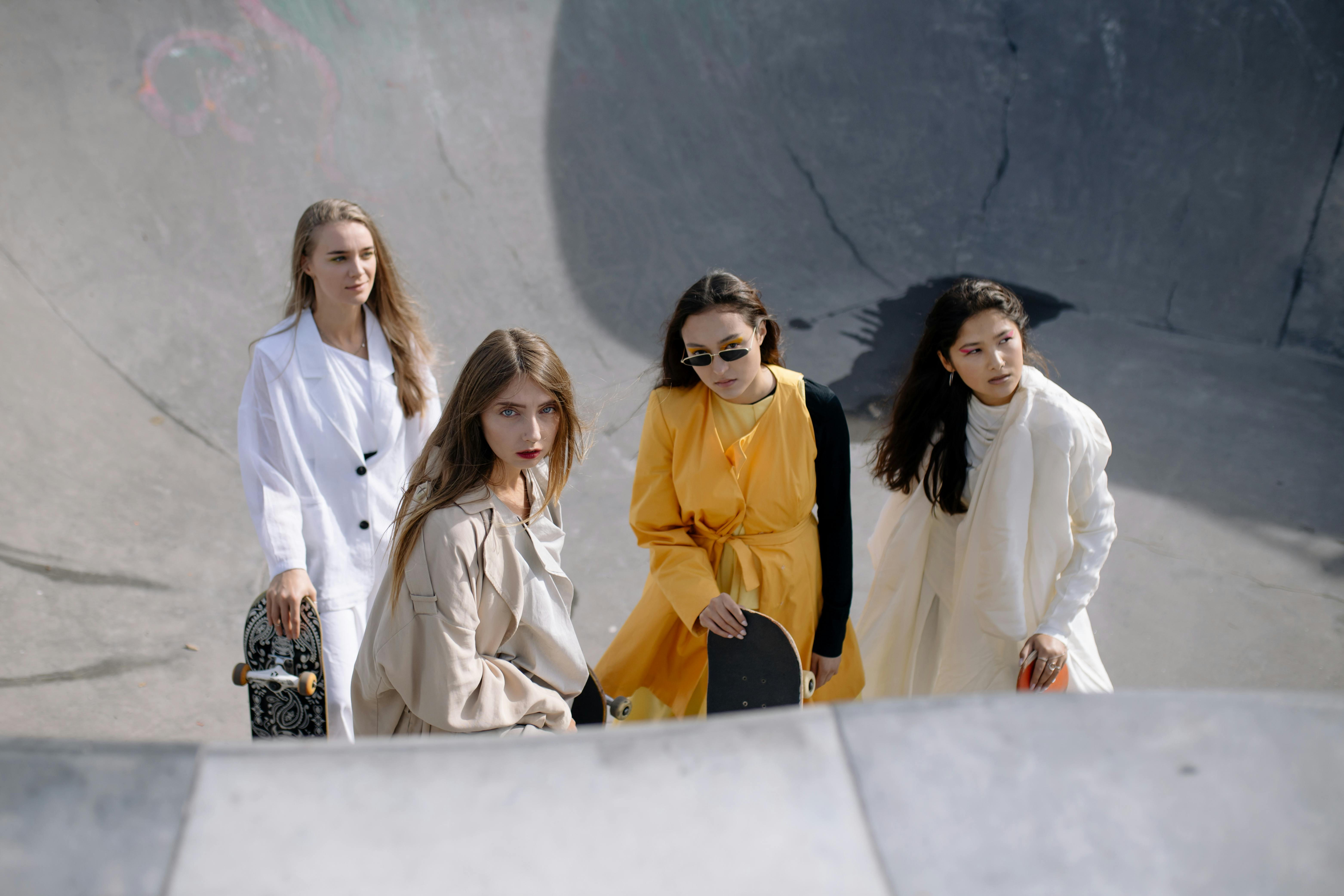 women in fashionable outfits posing in the skatepark