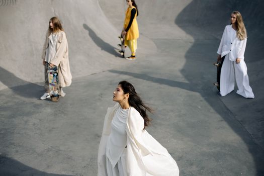 Stylish models with skateboards in a trendy skate park, showcasing urban fashion and dynamic youth culture.