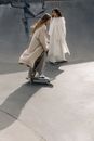 Woman in White Dress Standing on Gray Concrete Floor