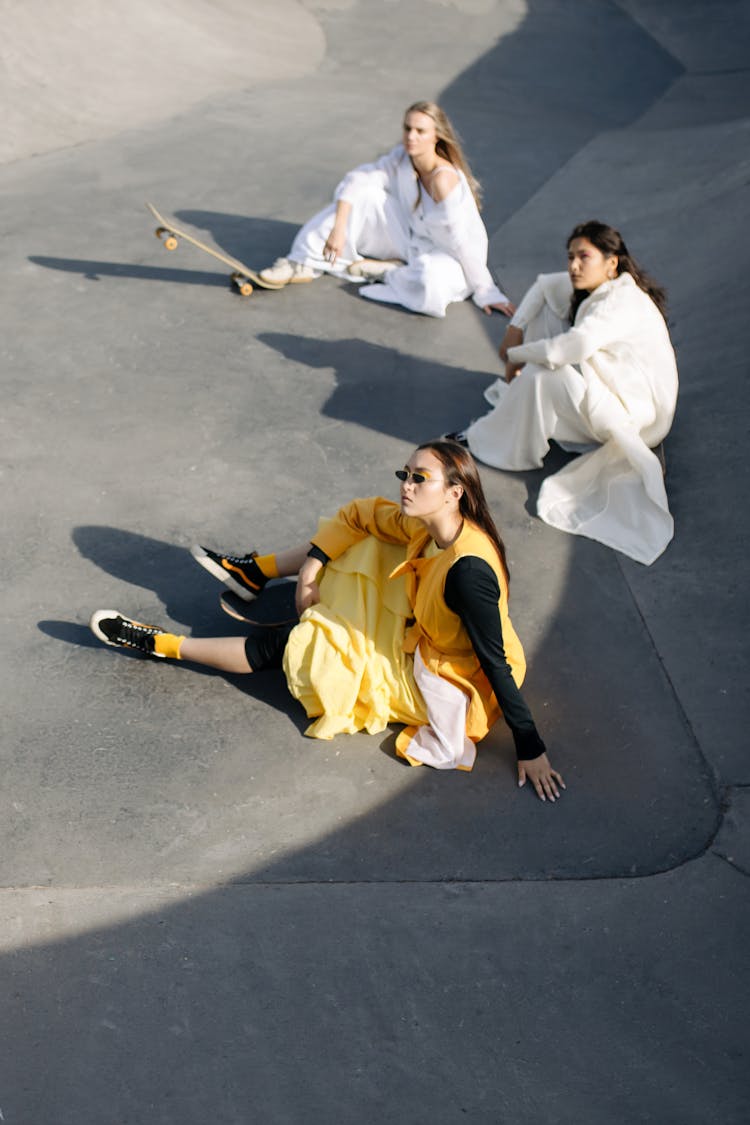 Stylish Women Sitting On The Ground