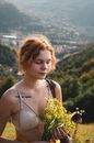 Woman Wearing Brassiere Holding Yellow Flowers