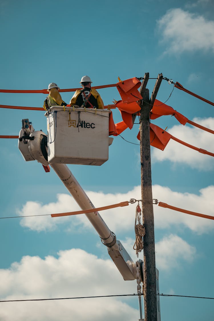 Workers Repairing A Utility Pole