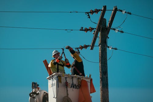 Free Electricians Fixing the Electric Lines Stock Photo
