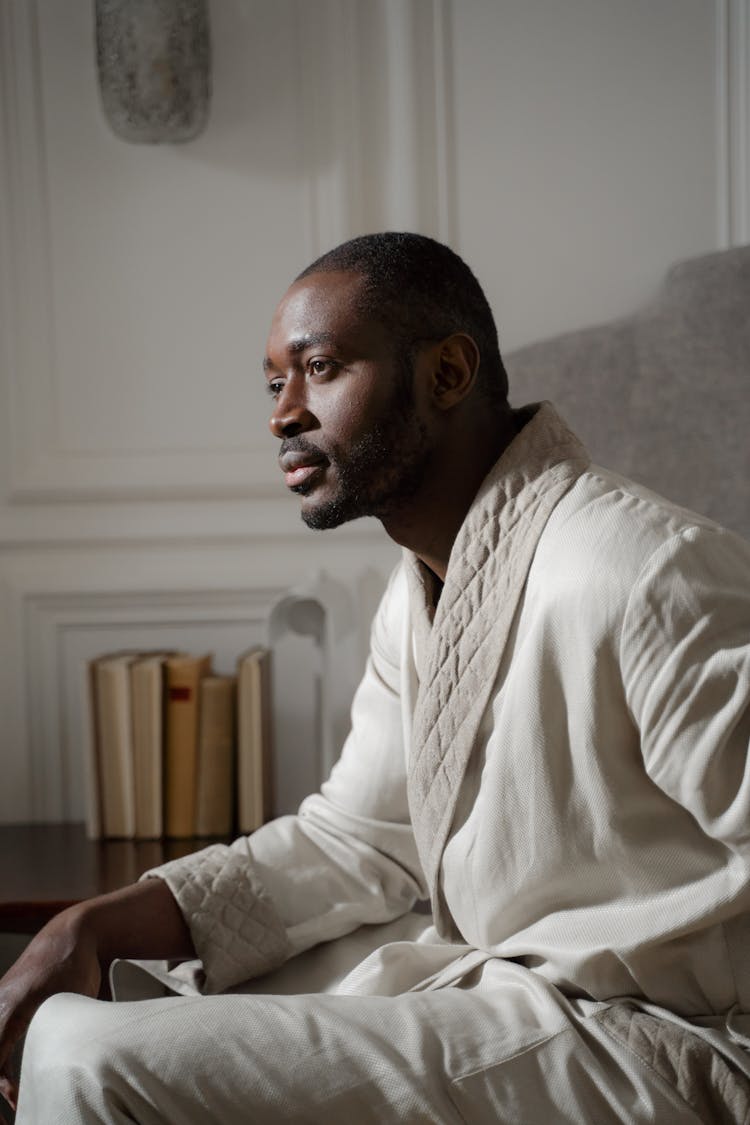 Man Sitting In The Bathrobe At Home