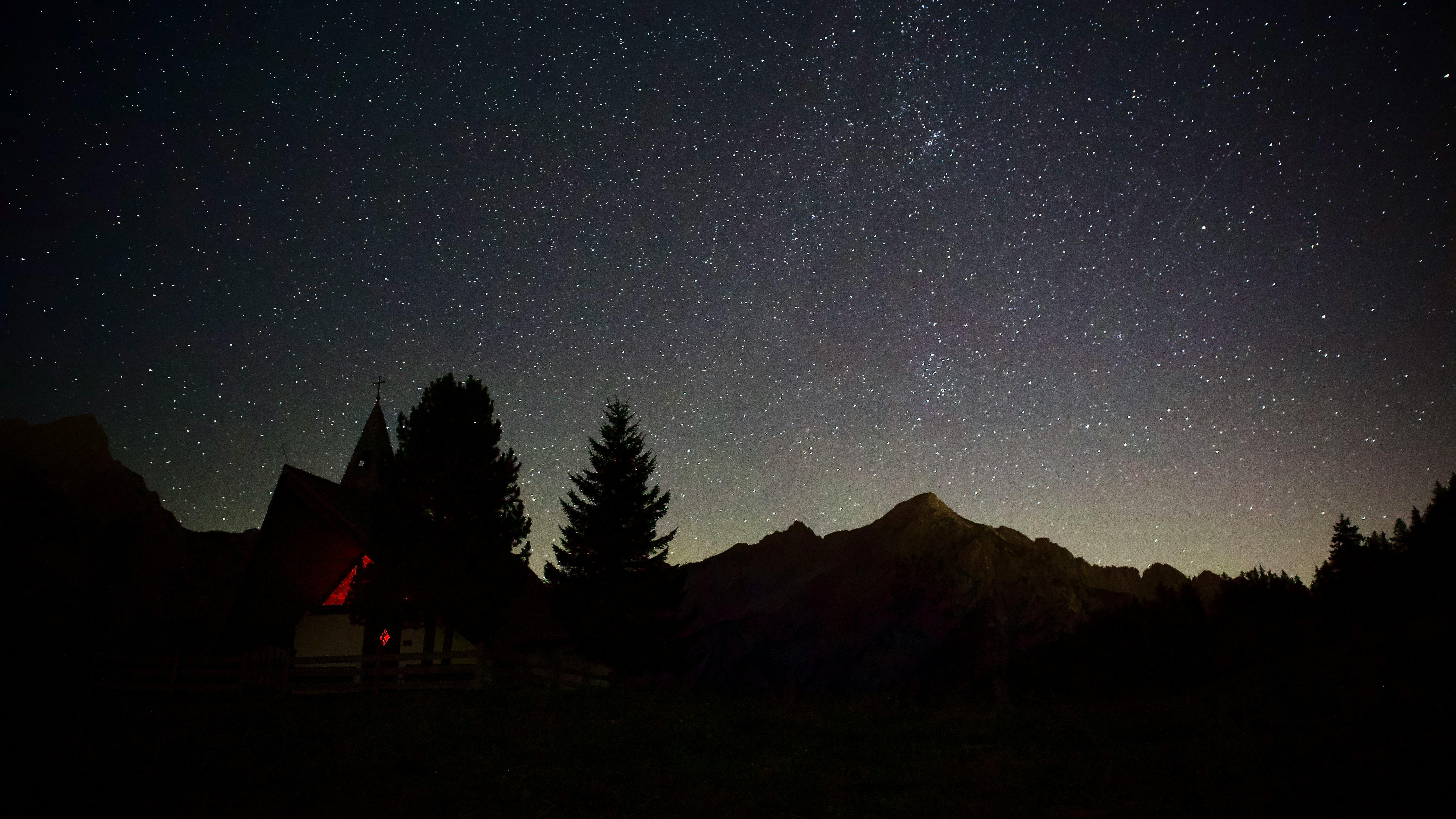 Captivating view of a starry night sky above the mountains in Gnadenwald, Tirol, Austria.