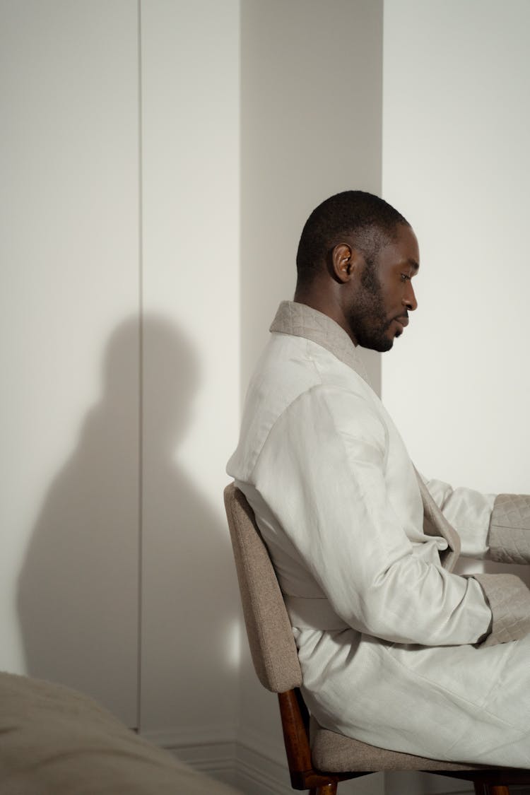 Side View Of Man In Bathrobe Sitting 