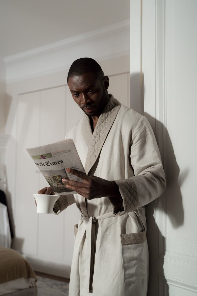 A Man Reading The Newspaper In The Morning