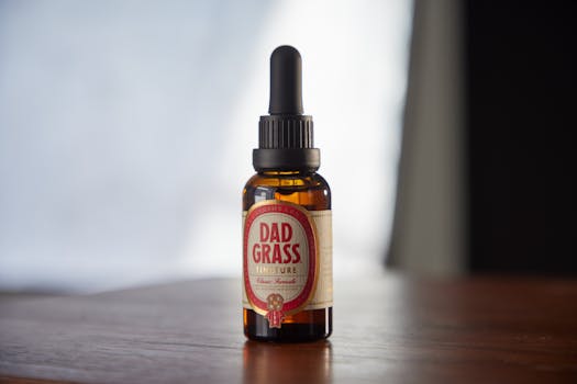 Close-up of a Dad Grass tincture bottle on a wooden surface, perfect for CBD-related concepts.