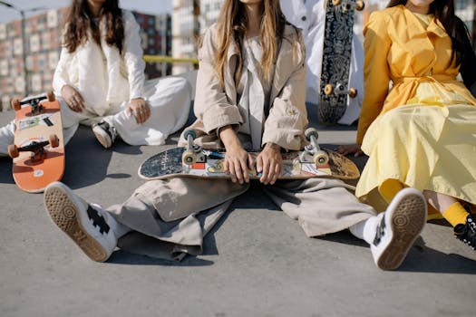 Fashionable young women posing with skateboards in an urban setting, showcasing stylish outfits and casual vibes.