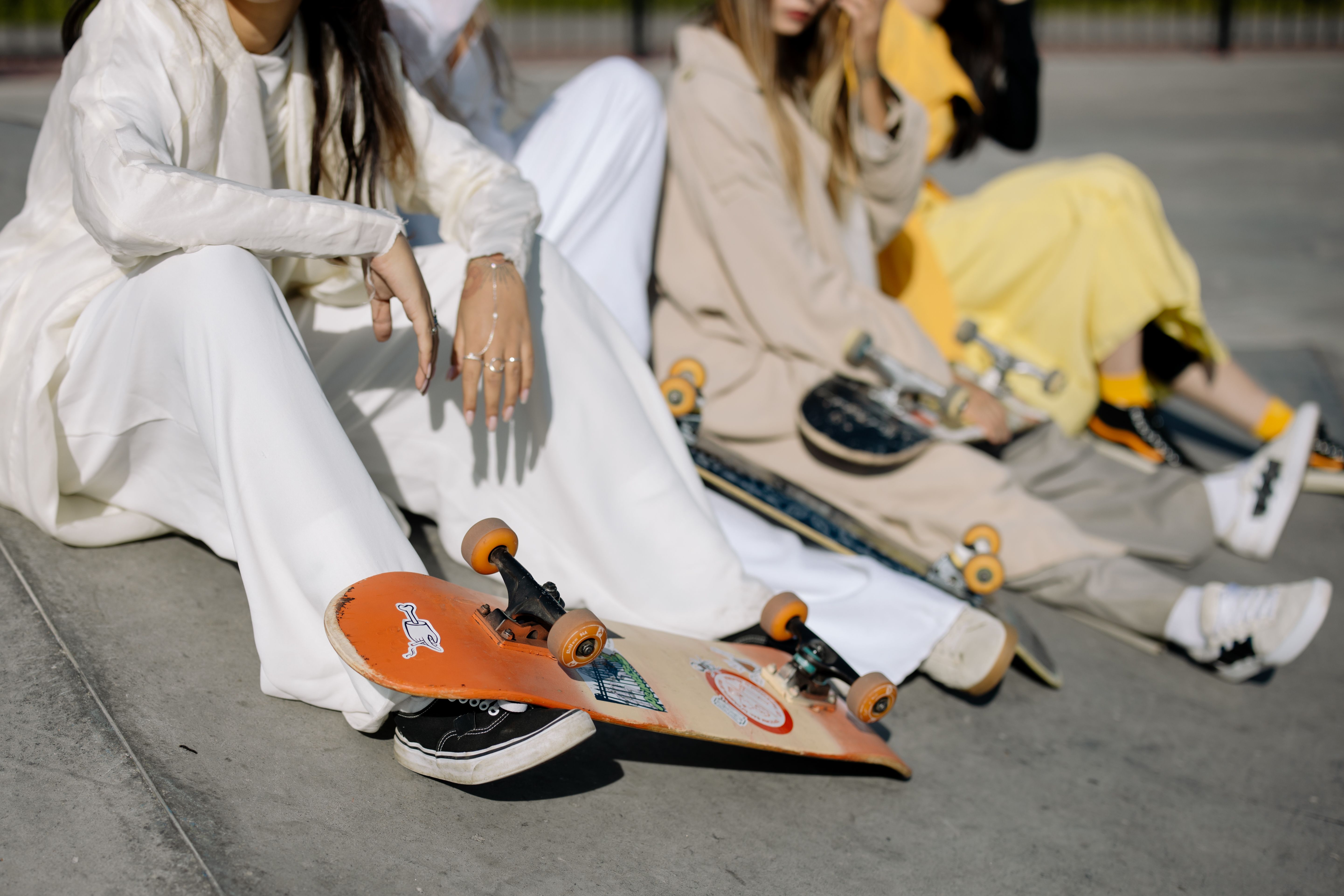 Members of the collective sitting with their skateboards at an outdoor skatepark in Lisbon