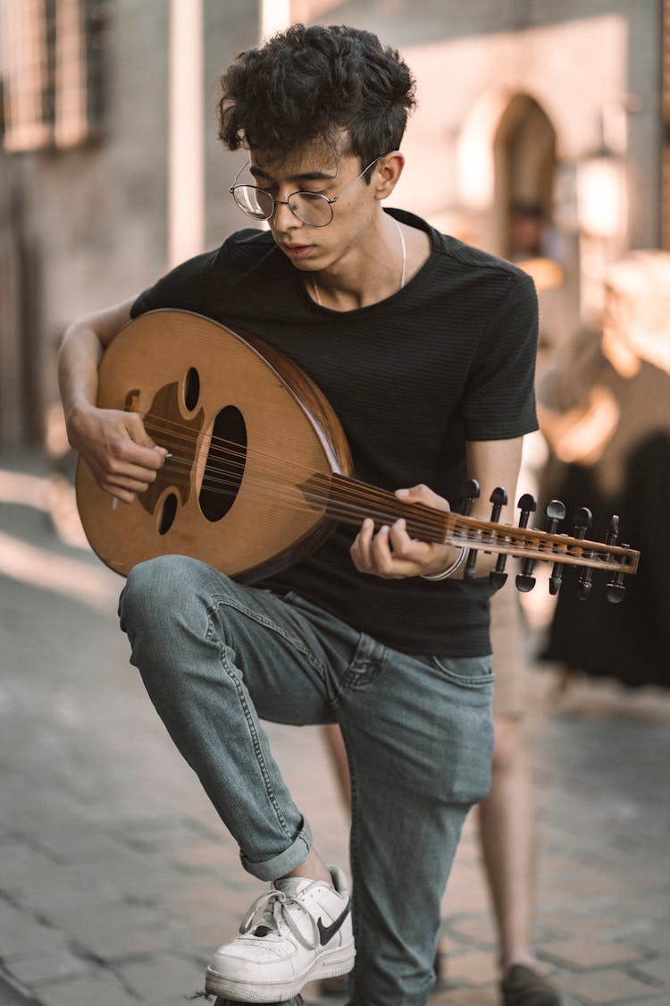 A Man Playing The Oud