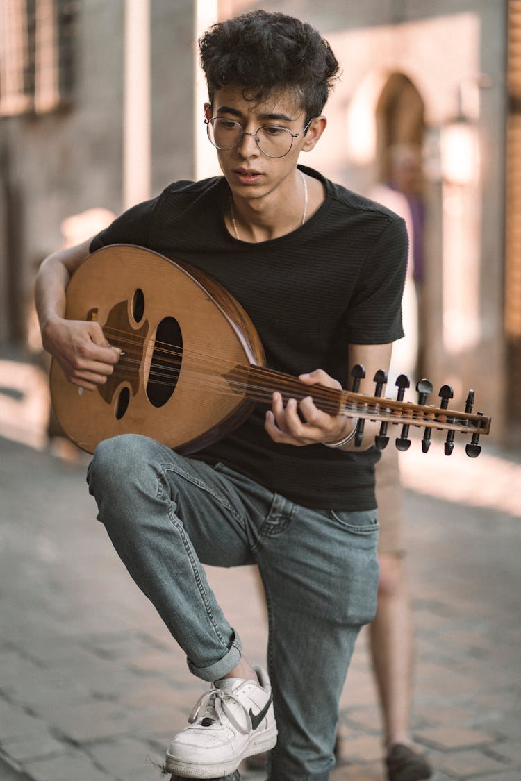 A Man Playing Music With An Oud