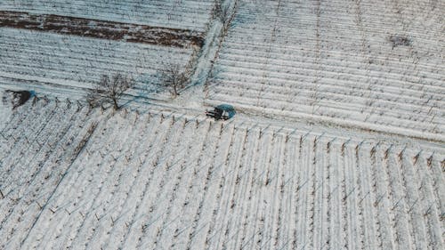 Aerial Shot of Black Car on the Road Covered with Snow 