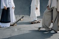 People Wearing Loose-Fitting Clothes Standing on Skateboards