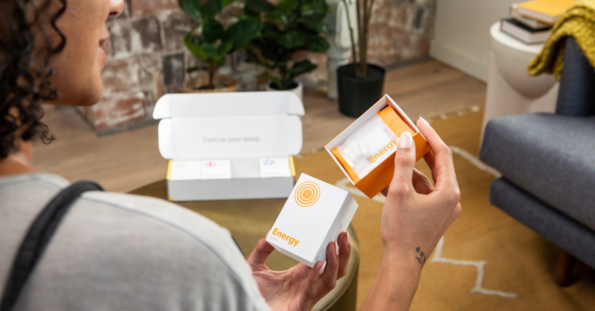 A woman holds energy supplements in a stylish living space, promoting wellness and lifestyle benefits.