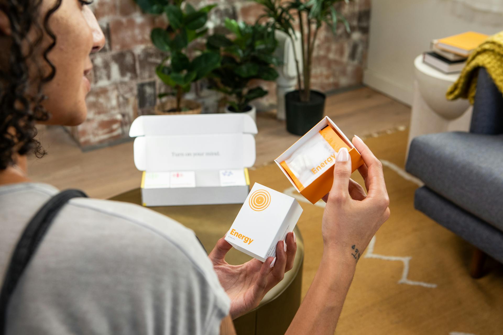 Photo of a Woman Holding a Package with Supplements