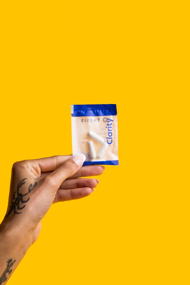 A Person Holding A Pack Of Pills With Clarity Label