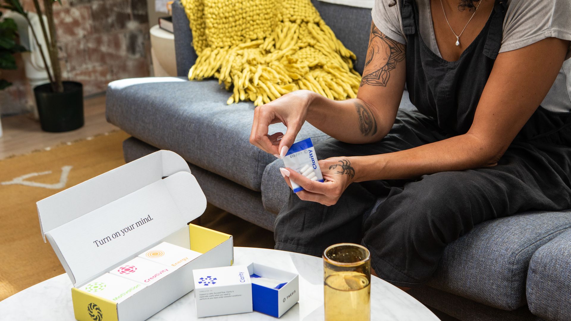Nootropics for Memory: Enhance Your Cognitive Abilities A woman sitting on a sofa examining nootropic supplements, promoting wellness and clarity — nootropics for memory