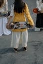 Woman in Yellow Long Sleeve Shirt and White Pants