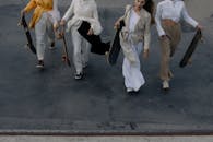 Group of People Carrying Skateboards