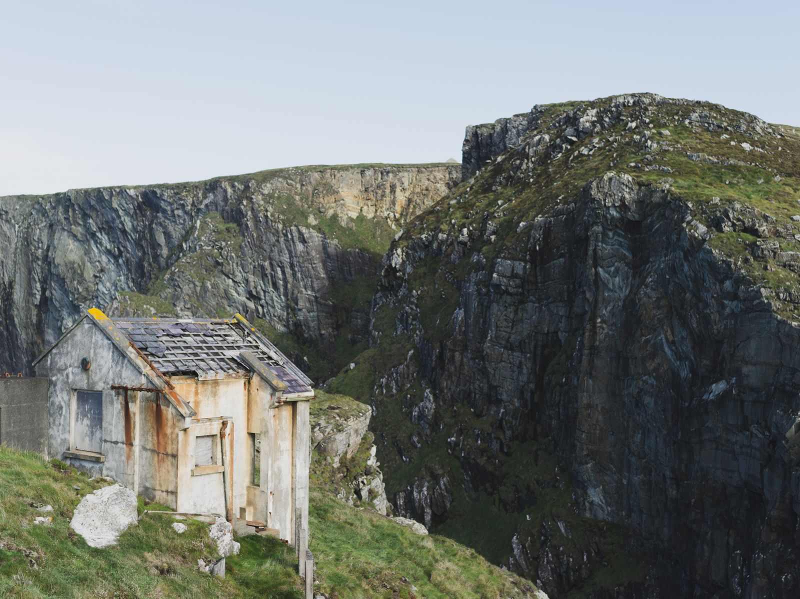 Rustic abandoned house perched on cliffs in Cork, Ireland