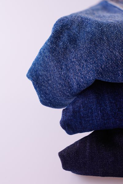 Stack of folded blue denim jeans — photo by Viktorya Sergeeva on Pexels