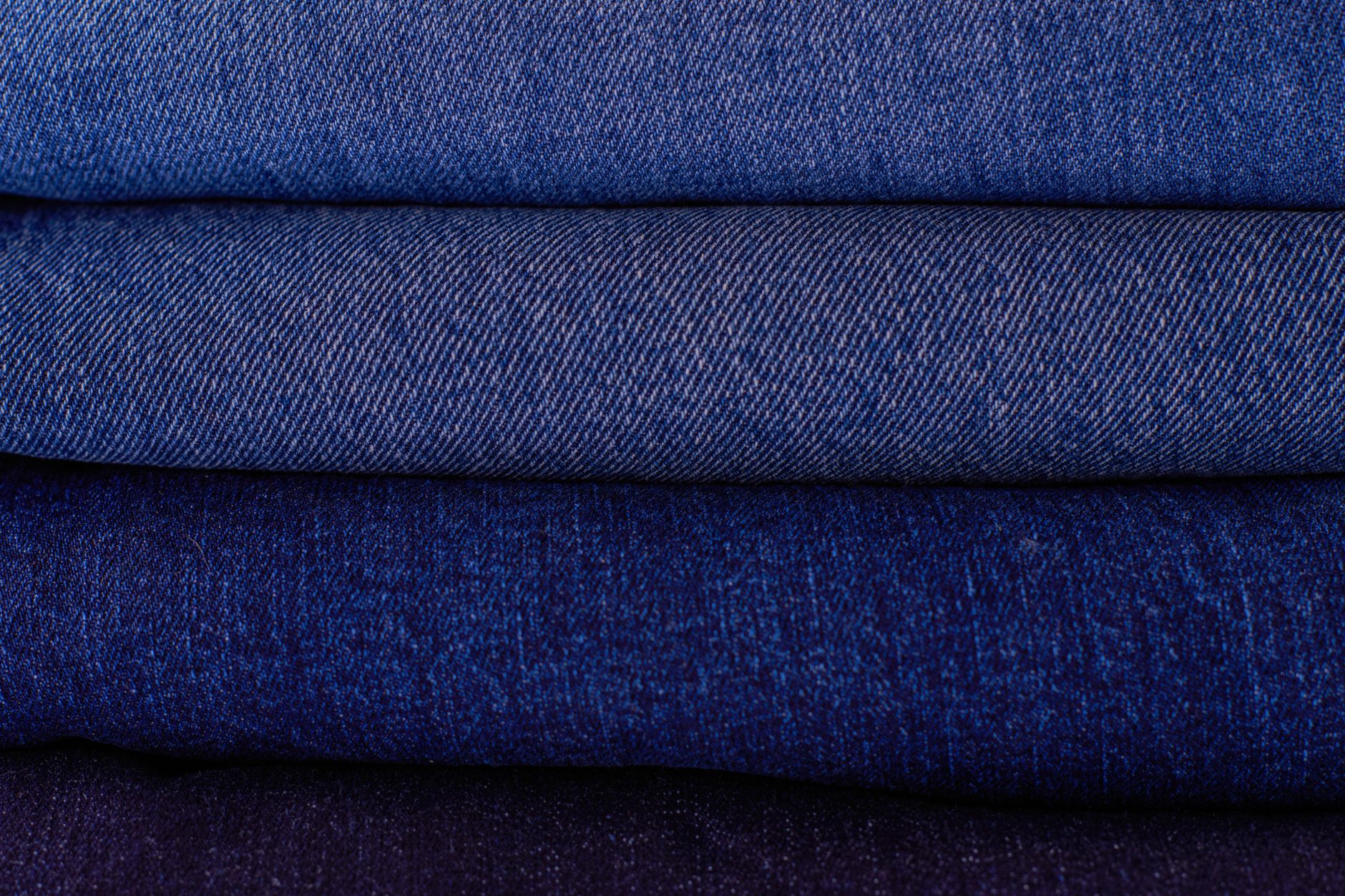 three denim swatches of different weights showing visible density differences