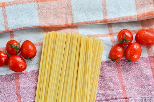 Red Tomatoes Beside Uncooked Pasta